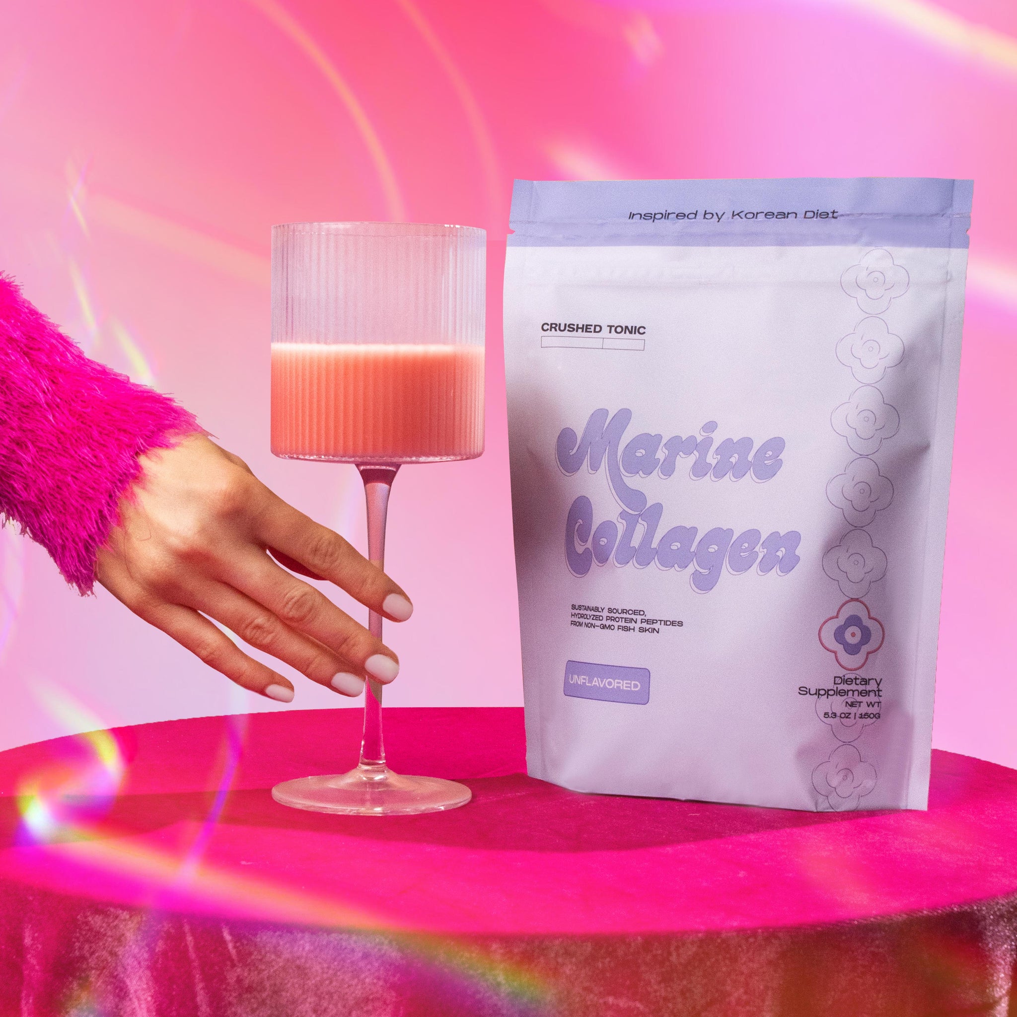 An image of Crushed Tonic's Unflavored Marine Collagen Pouch with a beautiful pink background.